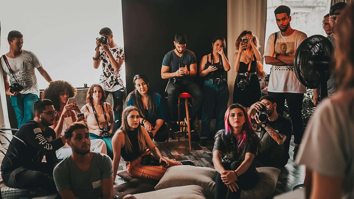 Tattoo artists talking and reviewing portfolios at a convention