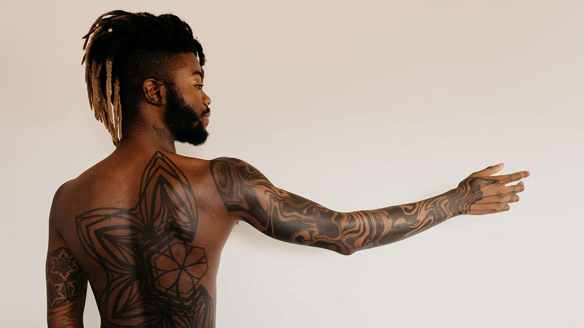 Tattoo artist working on a contemporary fine-line design