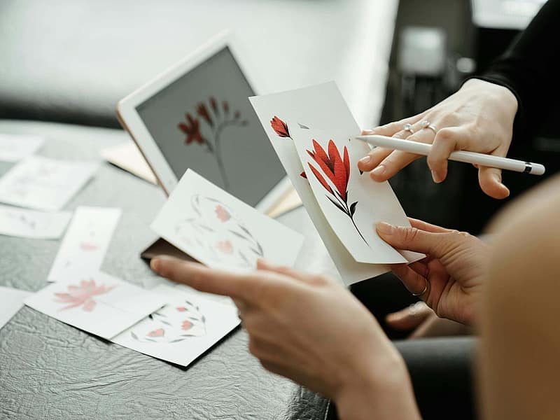 Client reviewing tattoo sketches with an artist