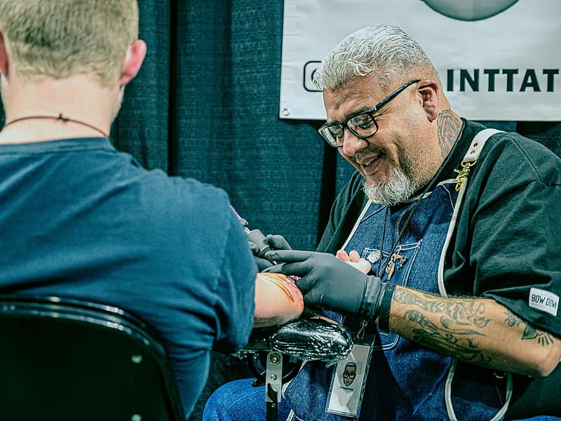 Tattoo artist listening to a client during a consultation