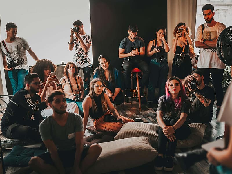 Tattoo artists talking and reviewing portfolios at a convention