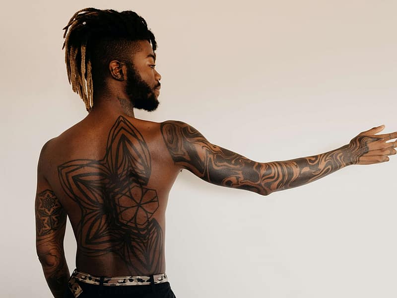 Tattoo artist working on a contemporary fine-line design