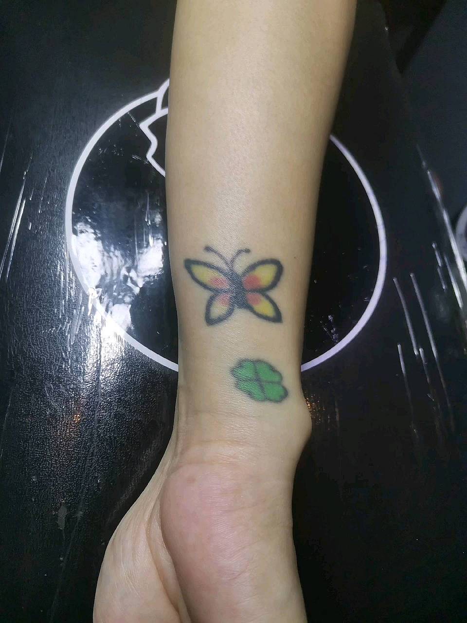 Butterfly and Four-Leaf Clover Wrist Tattoo