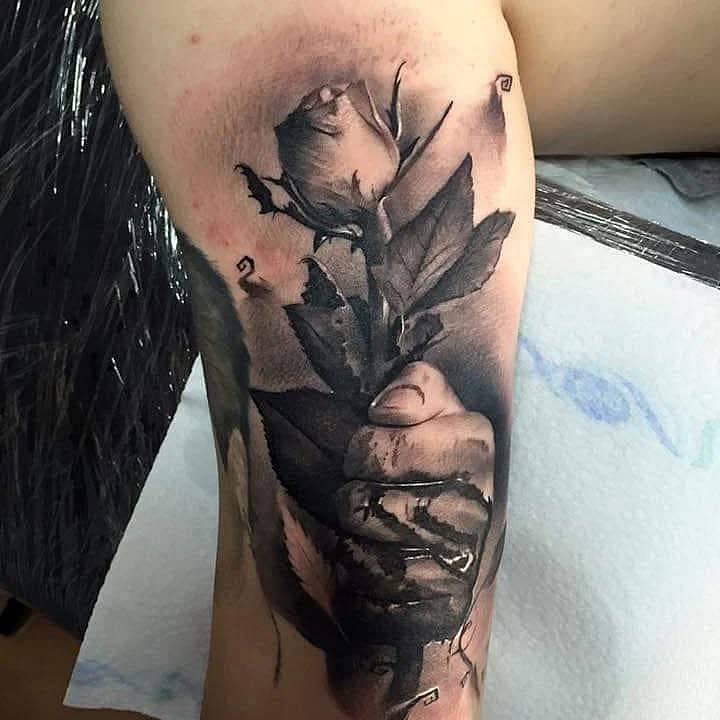 Clenched Hand Holding a Rose