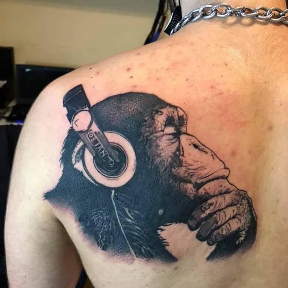 Contemplative Chimp with Headphones