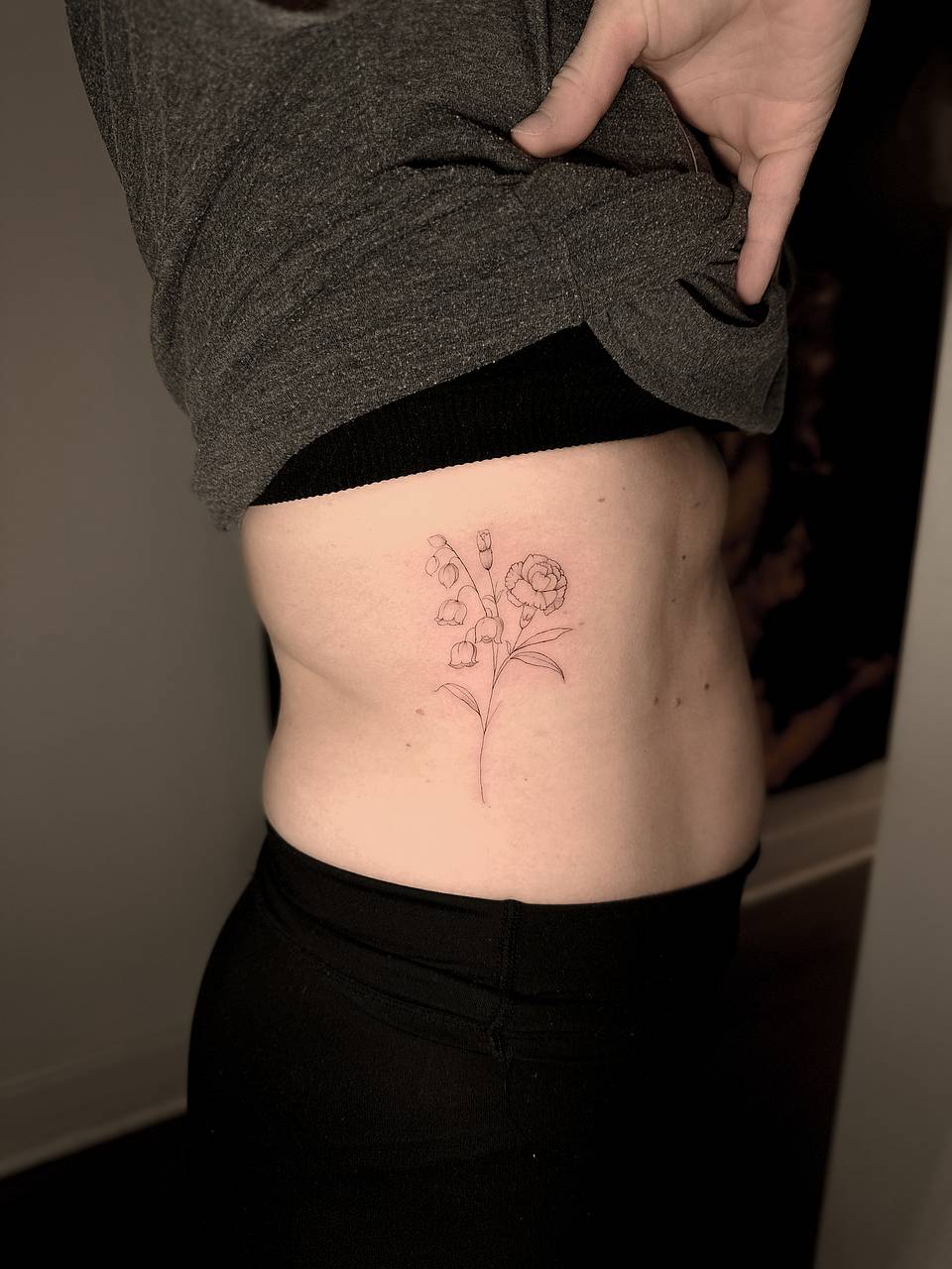 Delicate Lily-of-the-Valley & Ranunculus Rib Tattoo