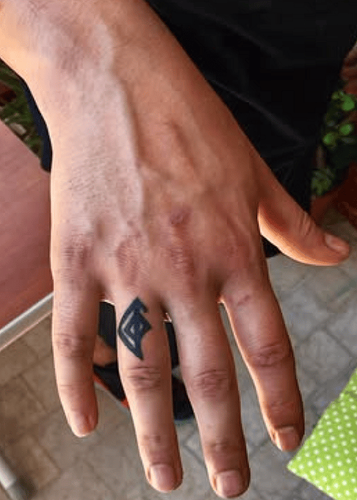 Geometric Eye Micro Tattoo on Ring Finger