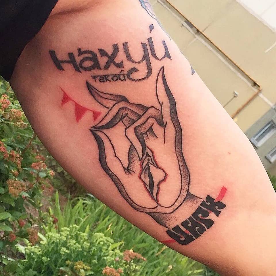 Hand Gesture with Vulva Motif and Cyrillic Script