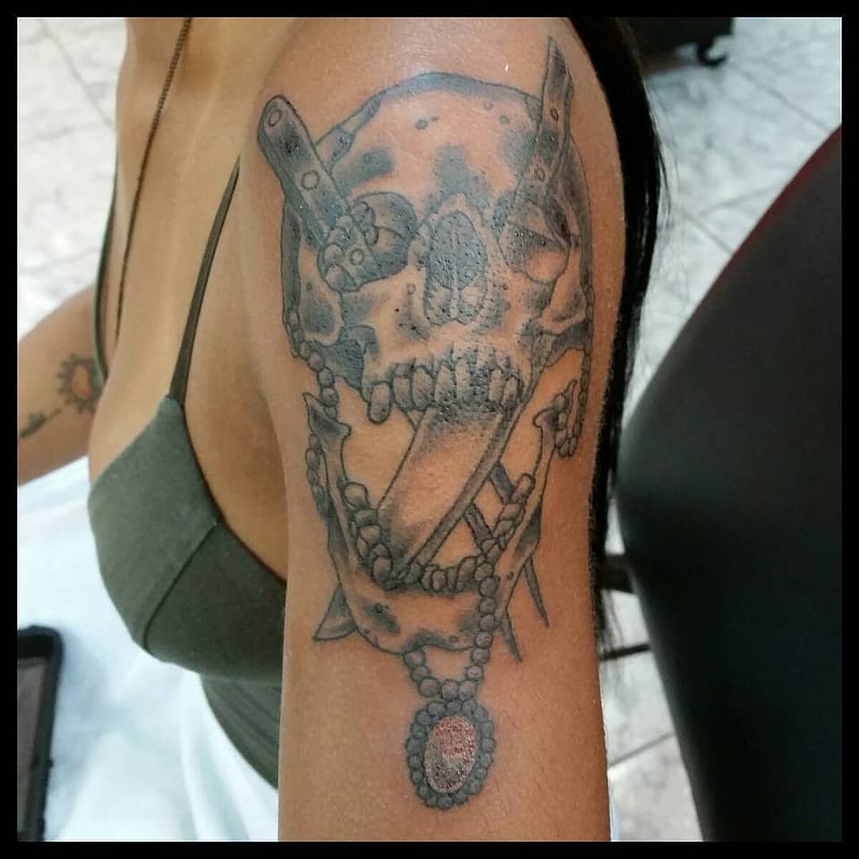 Rosary-Draped Skull with Daggers