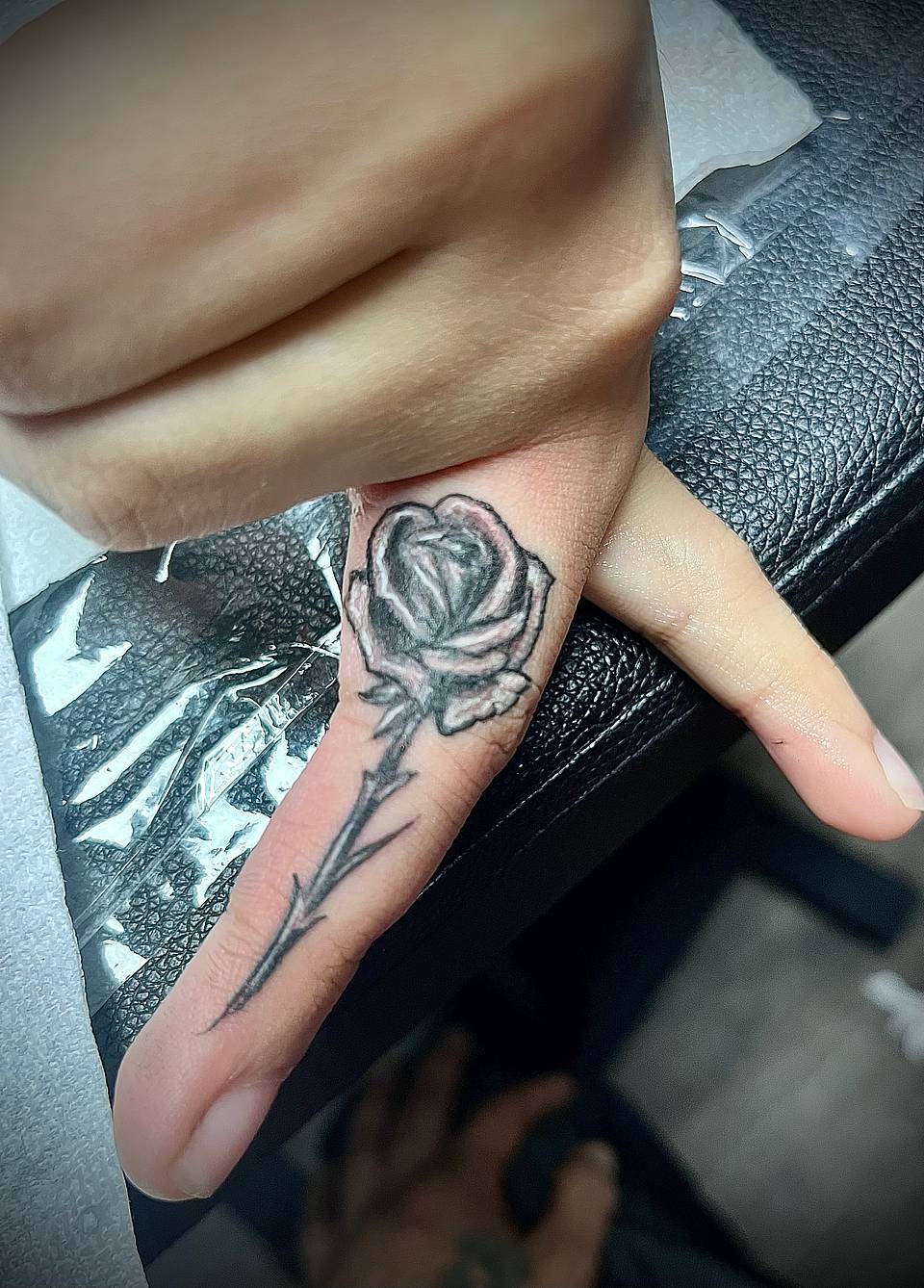 Single-Stem Rose Finger Tattoo
