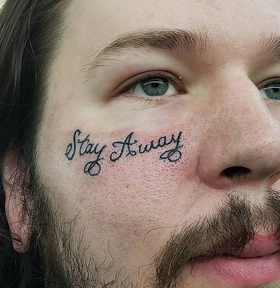 Stay Away Script Face Tattoo