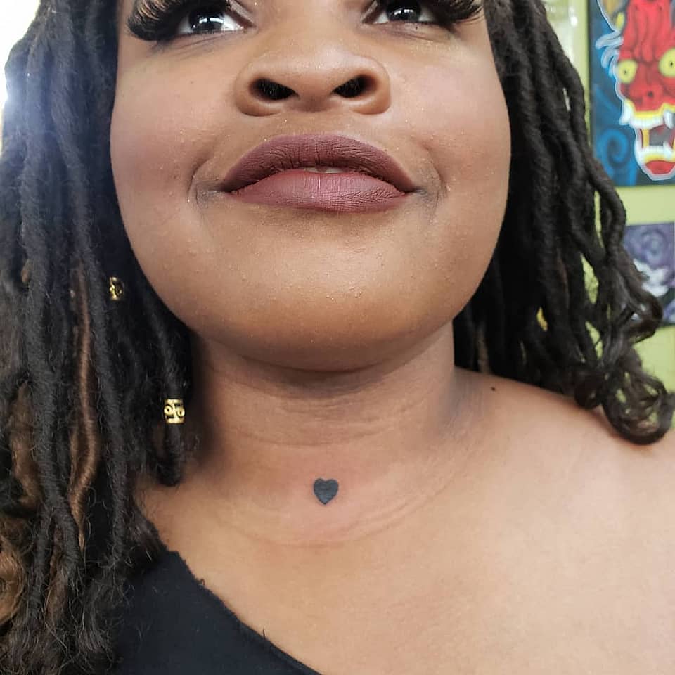 Tiny Black Heart Neck Tattoo